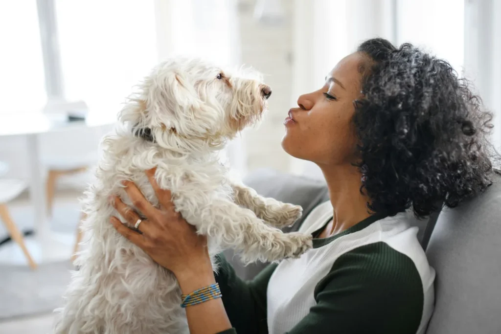 dog owner playing with her puppy